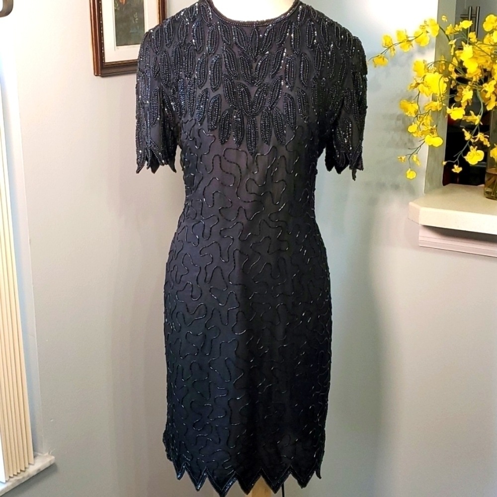Black beaded vintage dress is Vintage.  Short scalloped sleeve, hem‎ Wimsigoth